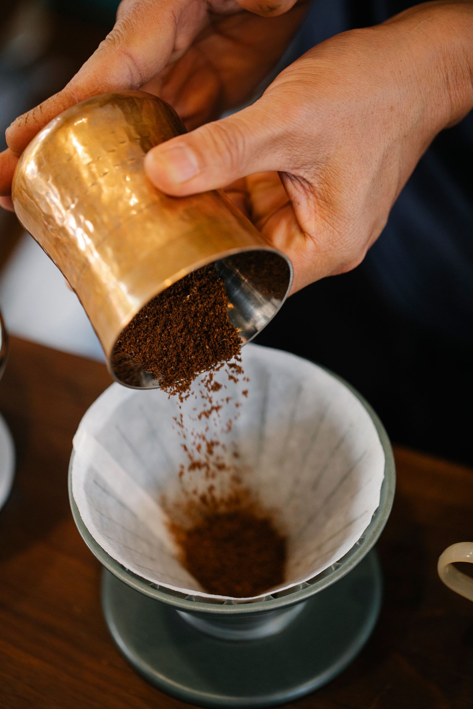 Barista pouring water over a coffee filter dripper