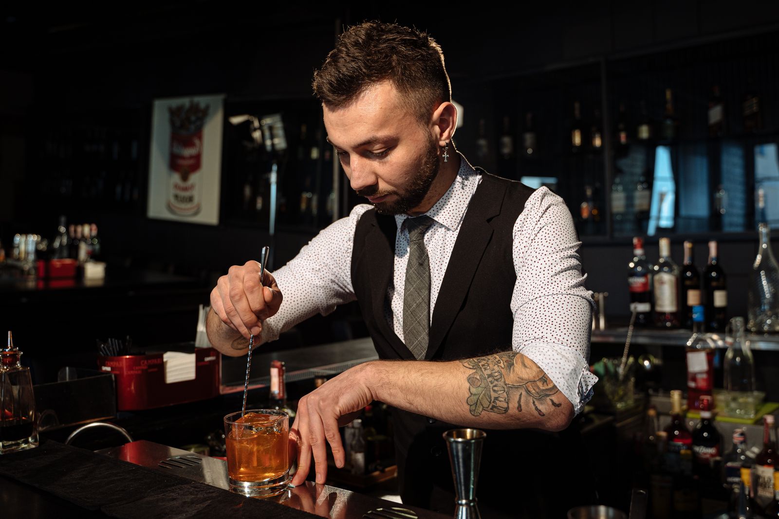 Bartender crafting a cocktail at a stylish bar