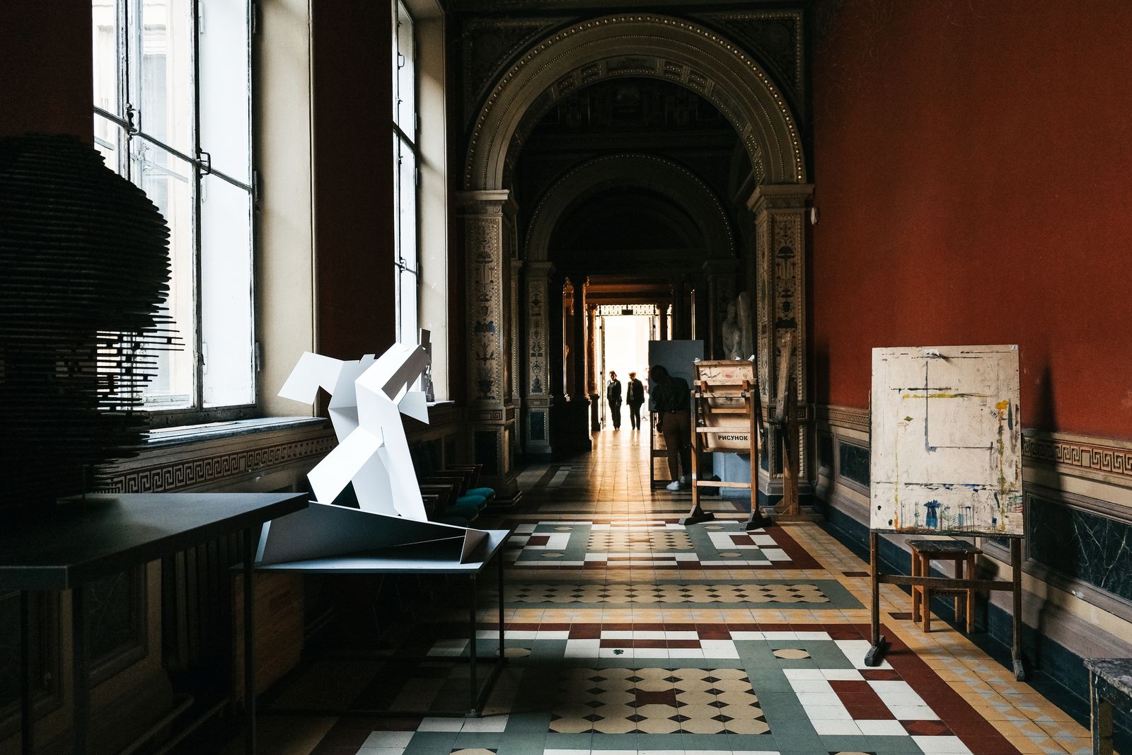 Dimly lit museum hallway with art installations