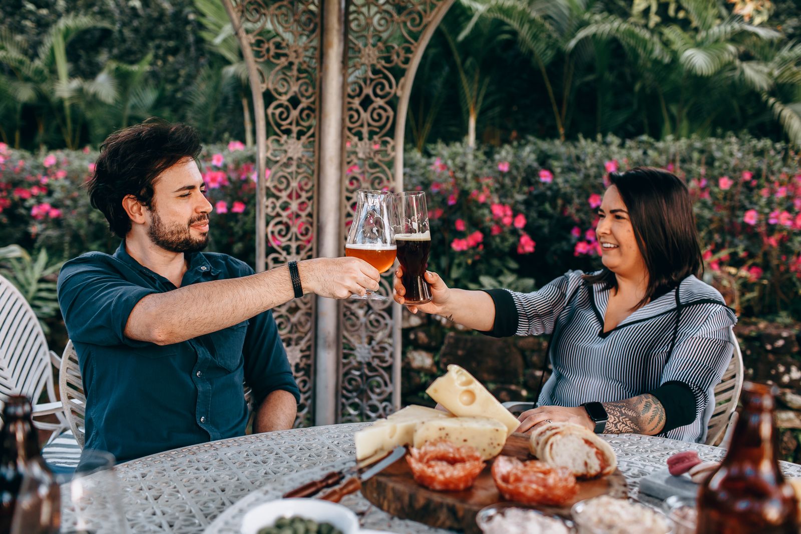Friends toasting with beer in a garden setting