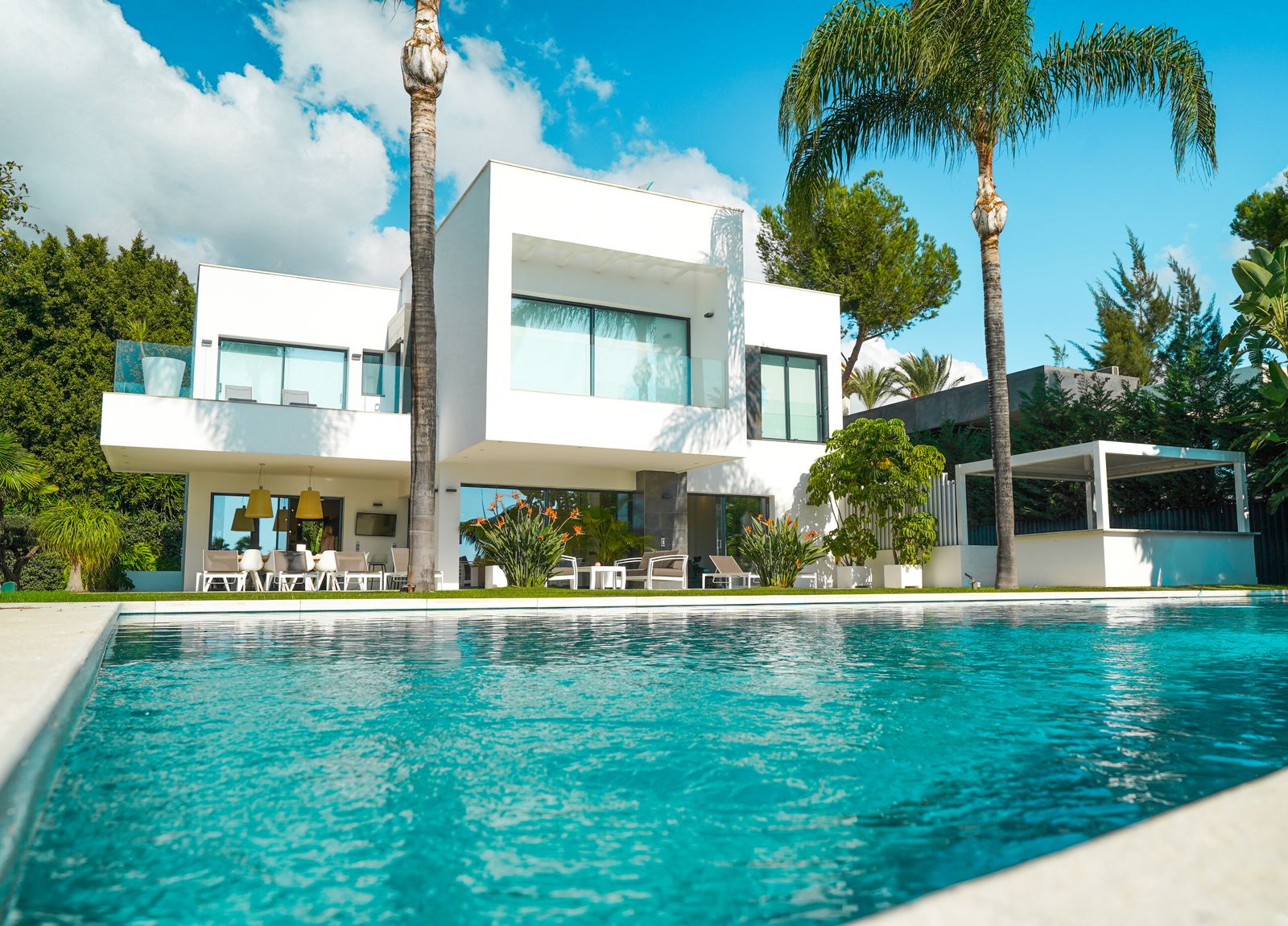 Modern luxury villa with a private pool in a sunlit garden