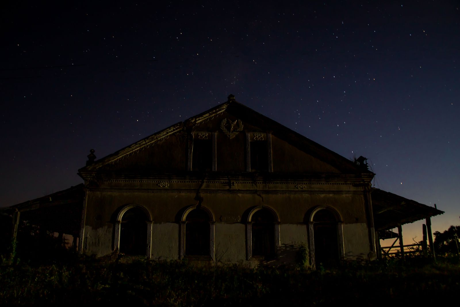 Eerie old historic building at night against a starry sky