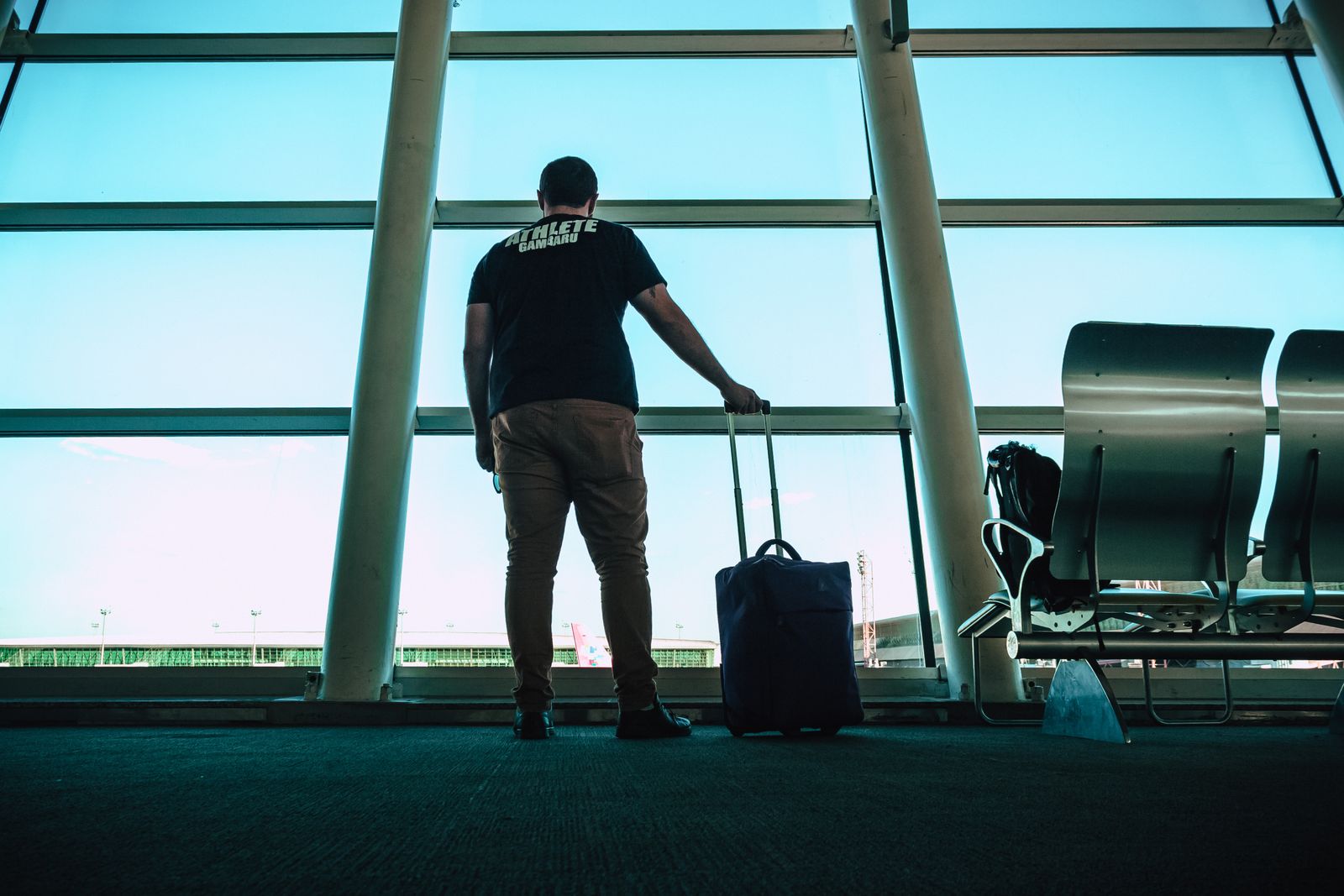 Traveler waiting with luggage at airport lounge