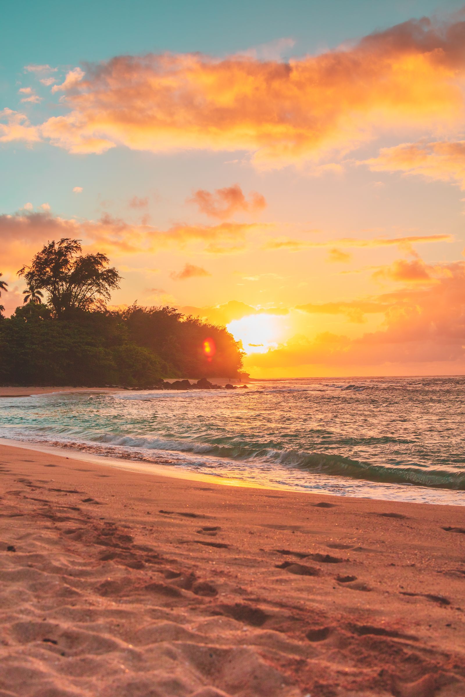 Sandy beach at sunrise with golden light