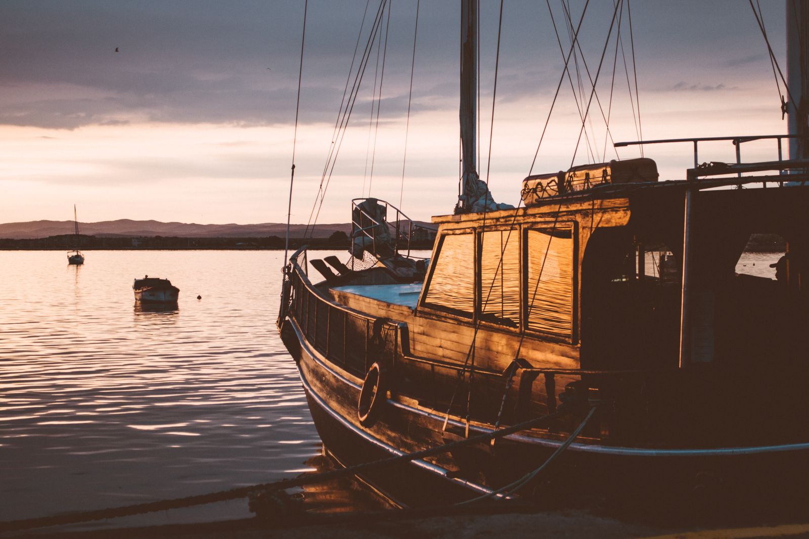 A boat on the water during a peaceful harbour sunset