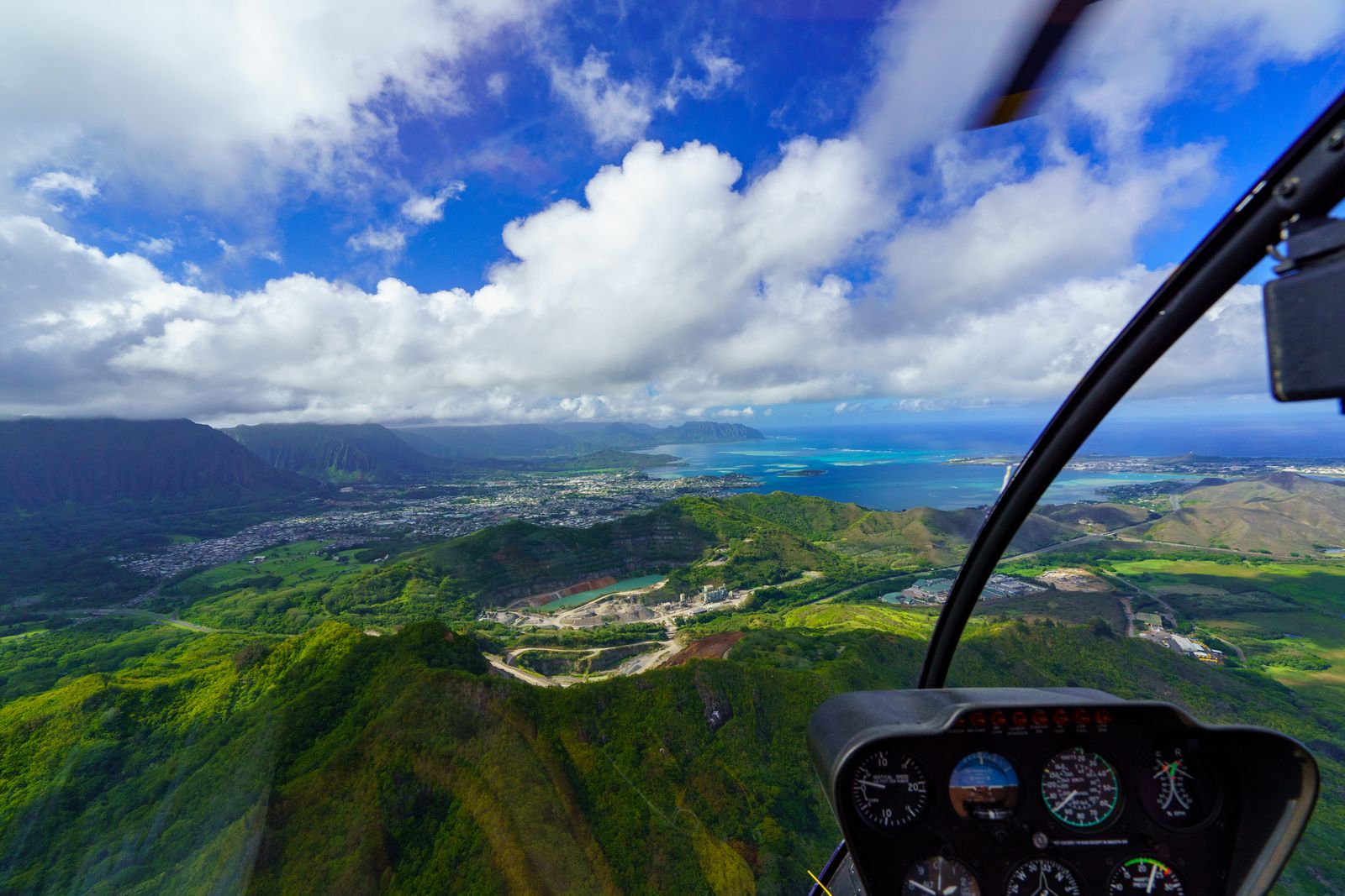 Aerial view of coastline and ocean from a helicopter cockpit