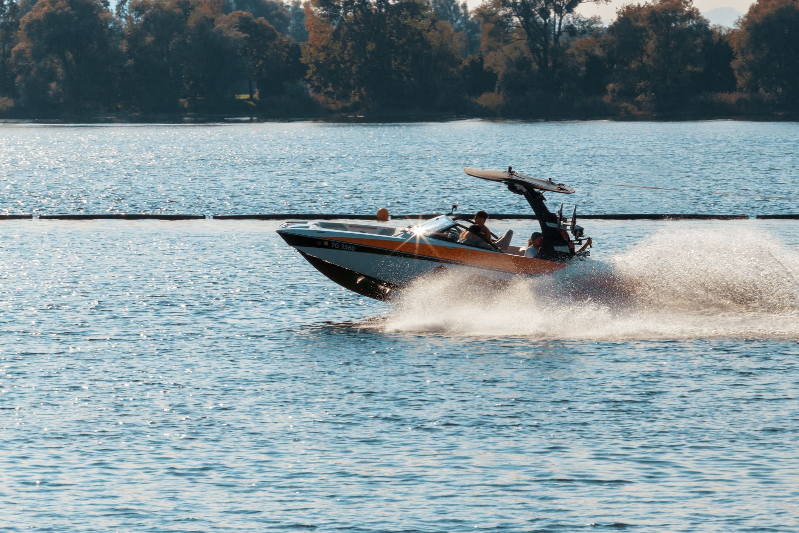 High-speed motorboat cutting through water with spray